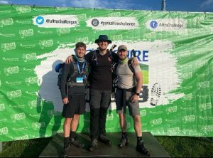 Supporters x 3 posing for picture at ultra challenge event