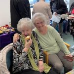 Members in Centre enjoying cake