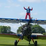 Supporter on plane on ground doing wing walk challenge